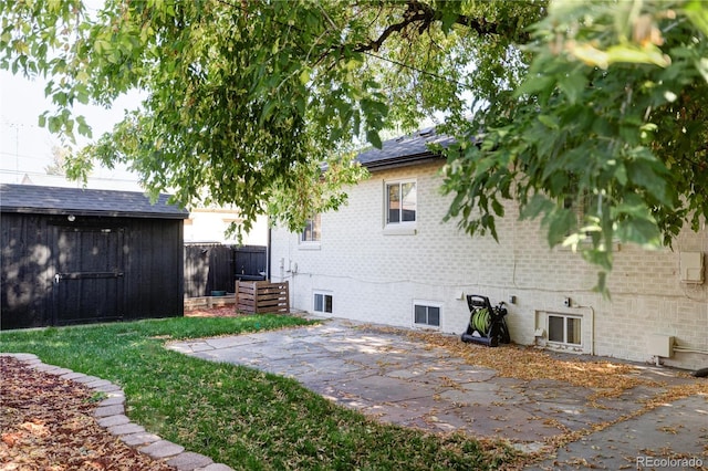 view of yard with a storage shed and a patio area