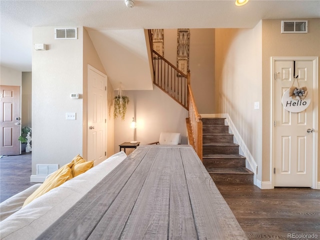 stairway with hardwood / wood-style flooring