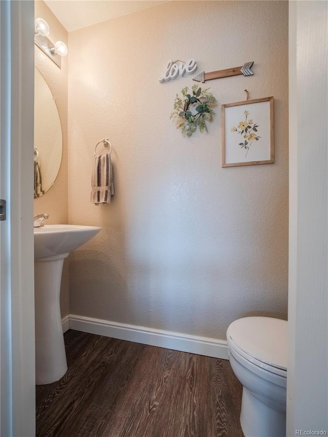 bathroom with sink, hardwood / wood-style flooring, and toilet