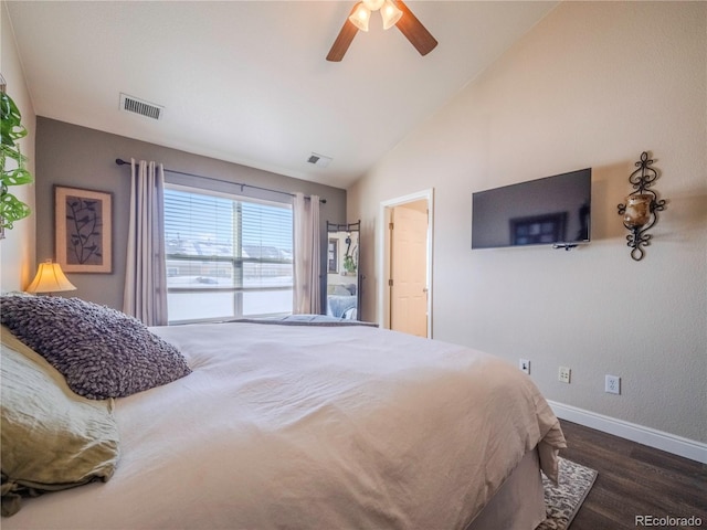 bedroom featuring dark hardwood / wood-style floors, vaulted ceiling, and ceiling fan