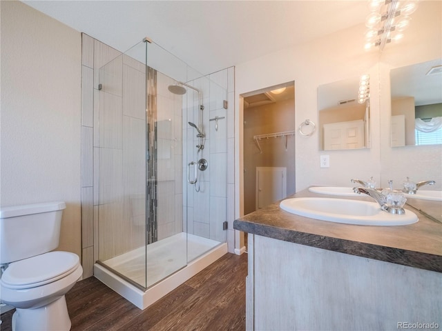 bathroom with vanity, hardwood / wood-style flooring, an enclosed shower, and toilet