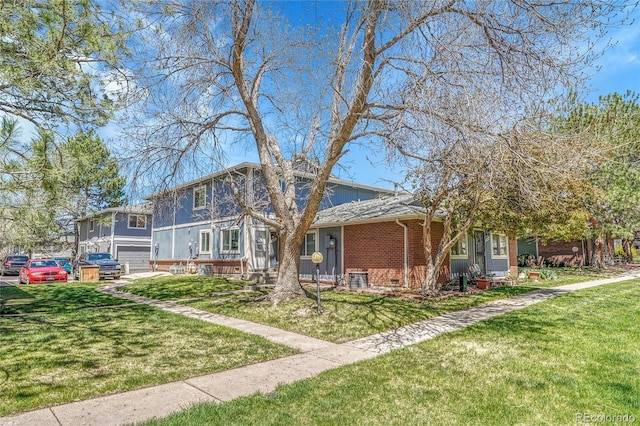 view of front of house with brick siding and a front lawn