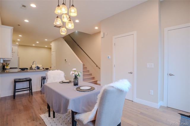 dining space featuring light wood-type flooring