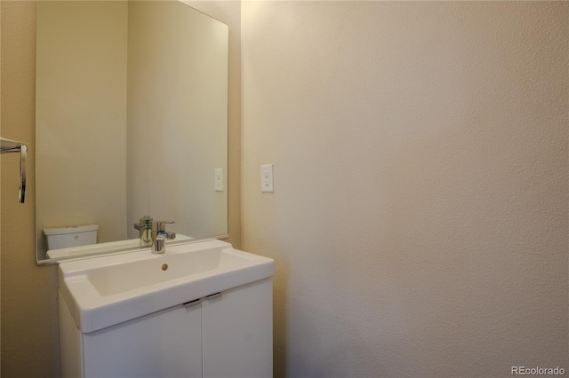 bathroom with toilet and vanity