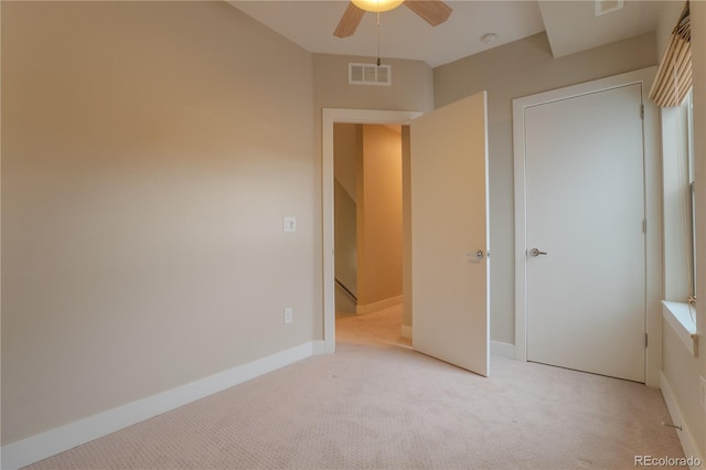 unfurnished bedroom with light carpet and ceiling fan