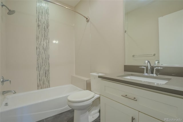 full bathroom featuring tile patterned floors, tiled shower / bath combo, vanity, and toilet