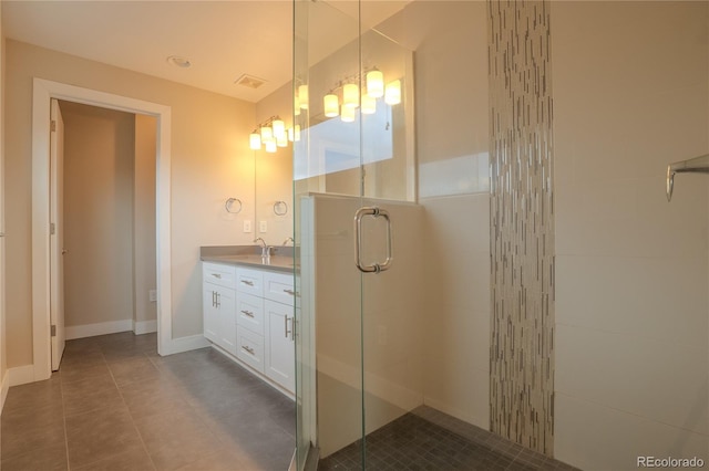 bathroom with vanity, tile patterned flooring, and a shower with door