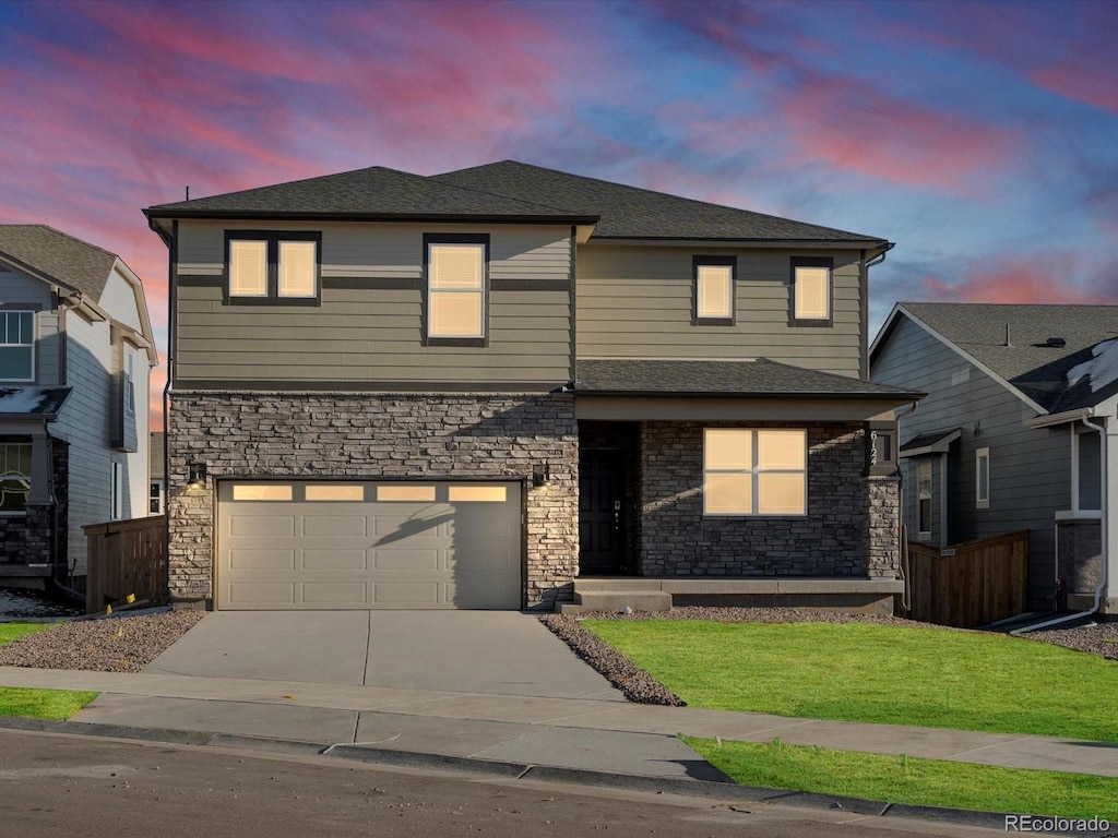 view of front facade featuring a lawn and a garage