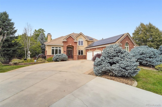 view of front property featuring solar panels and a garage