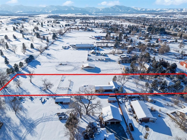 snowy aerial view featuring a mountain view