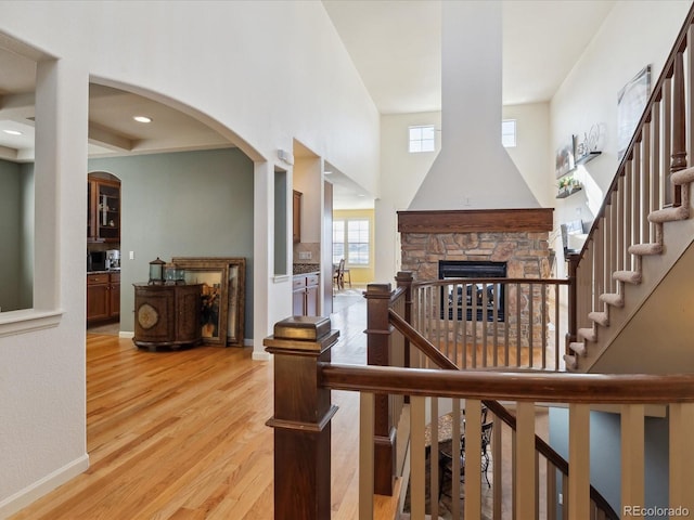 stairway featuring a fireplace and hardwood / wood-style flooring