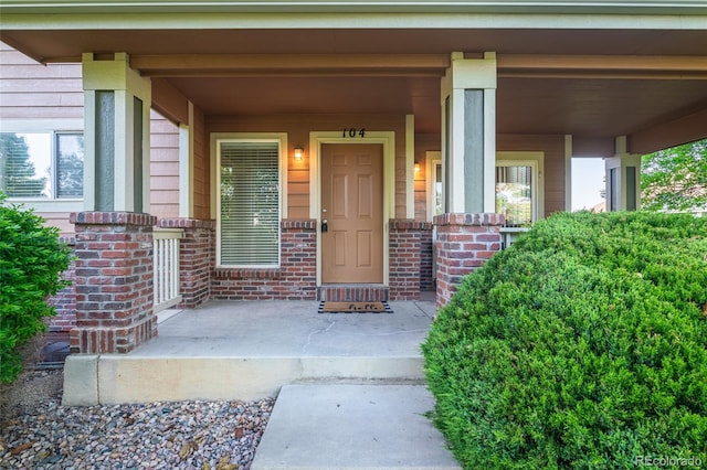 135 Carina Cir Unit 104, Loveland, CO 80537 - property entrance with a porch and brick siding