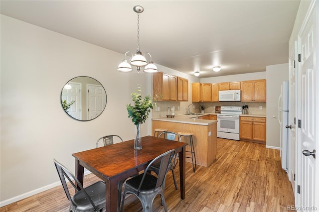 135 Carina Cir Unit 104, Loveland, CO 80537 - dining room with light wood-style floors and a chandelier