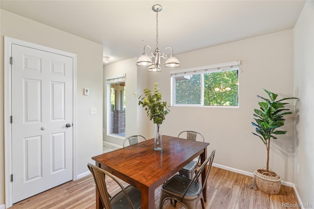 135 Carina Cir Unit 104, Loveland, CO 80537 - dining area with light wood-style floors and a chandelier