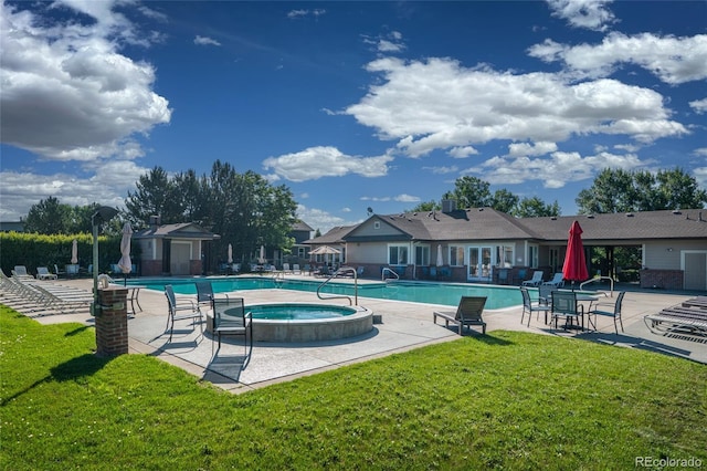 135 Carina Cir Unit 104, Loveland, CO 80537 - community pool with a hot tub, a lawn, and a patio