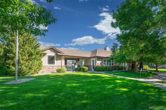 135 Carina Cir Unit 104, Loveland, CO 80537 - ranch-style home with a front lawn, a chimney, and stone siding