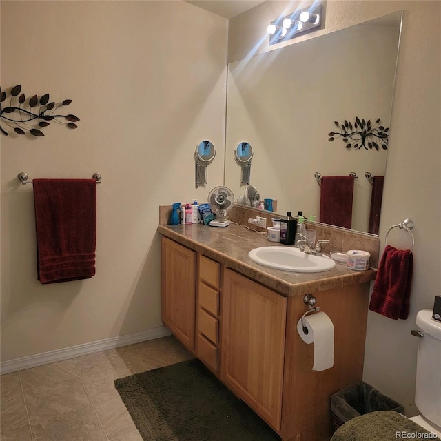 bathroom with vanity, toilet, and tile patterned floors