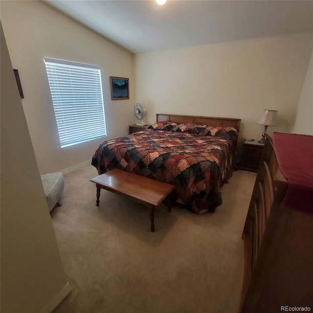 carpeted bedroom featuring lofted ceiling