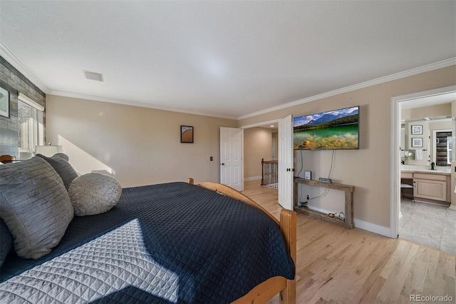 bedroom featuring visible vents, baseboards, connected bathroom, crown molding, and light wood-style floors