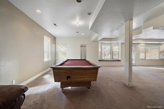 rec room with visible vents, light carpet, and a textured ceiling