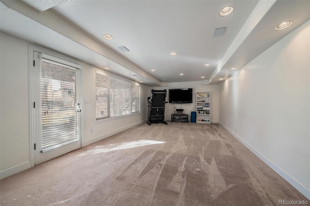 unfurnished living room featuring baseboards, recessed lighting, and light colored carpet