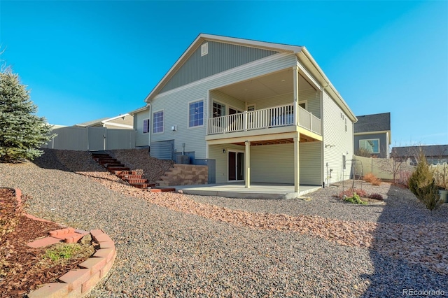 back of house with a balcony and a patio area