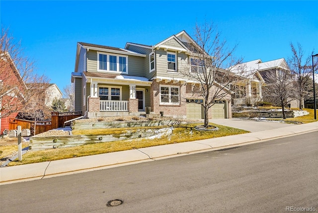 craftsman inspired home featuring brick siding, fence, concrete driveway, covered porch, and an attached garage