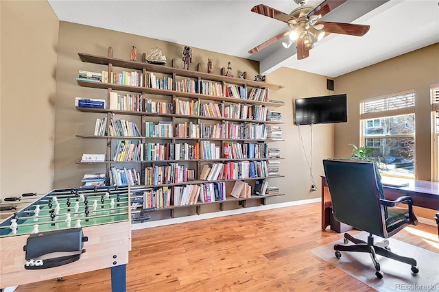 office area with wood finished floors, baseboards, and ceiling fan