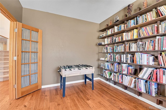 playroom featuring wood finished floors and baseboards