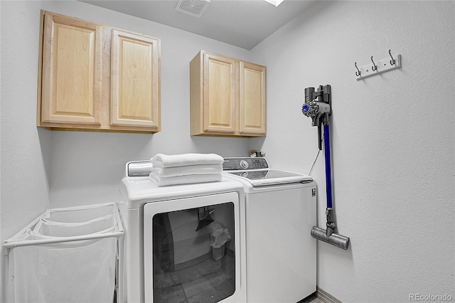 laundry room featuring visible vents, cabinet space, and independent washer and dryer