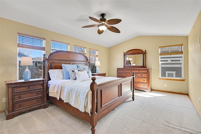 bedroom with baseboards, light colored carpet, a ceiling fan, and vaulted ceiling