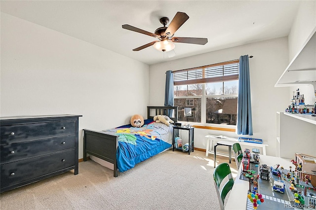 bedroom with a ceiling fan, baseboards, and carpet floors