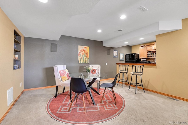 dining area with recessed lighting, visible vents, baseboards, and light colored carpet