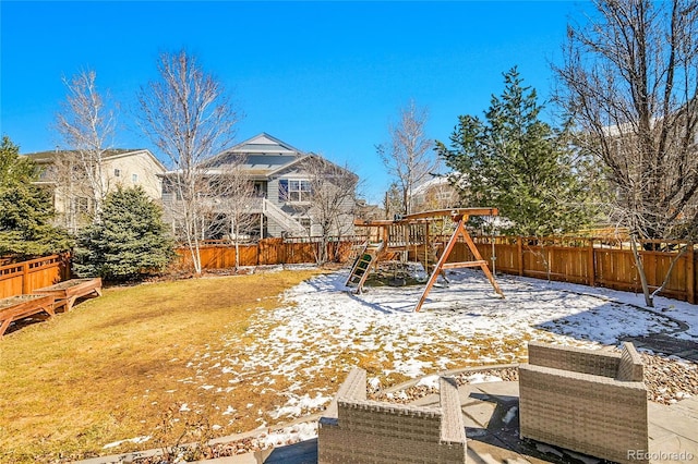 view of yard with a fenced backyard and a playground