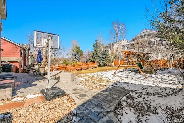 exterior space featuring a patio, a playground, and a fenced backyard