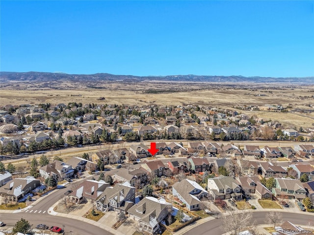 birds eye view of property with a mountain view and a residential view