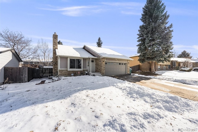 ranch-style house with a garage, fence, and a chimney