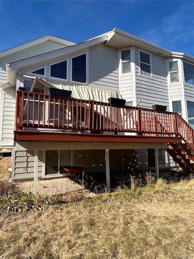 back of property featuring a wooden deck