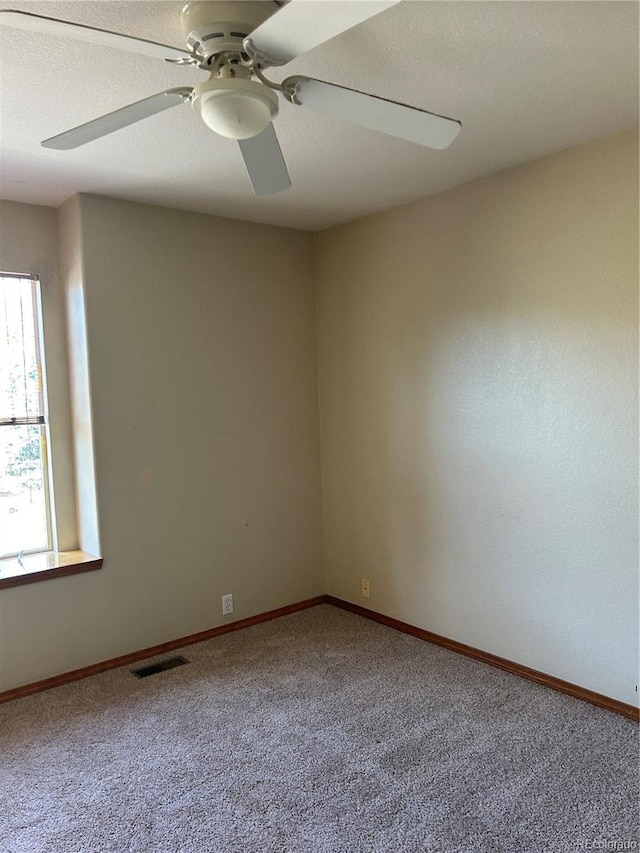 empty room featuring carpet and ceiling fan