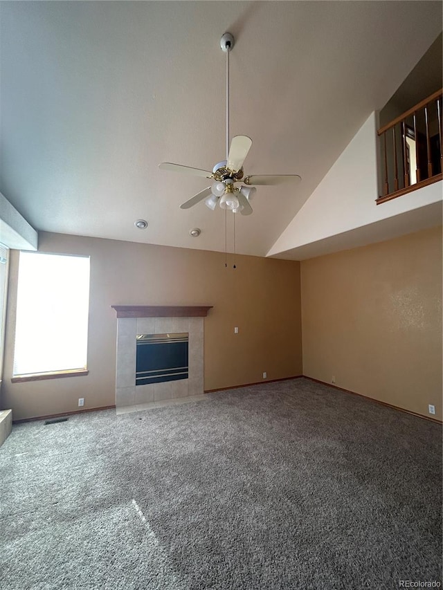 unfurnished living room featuring carpet flooring, high vaulted ceiling, ceiling fan, and a fireplace