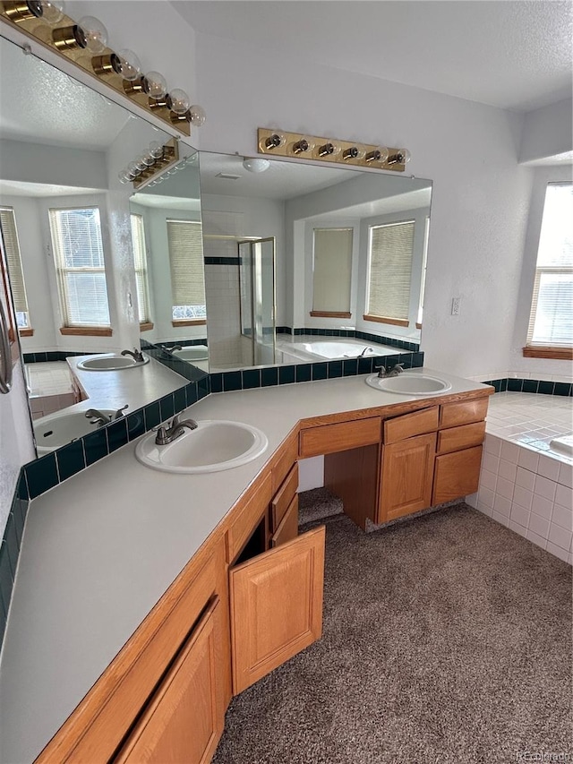 bathroom featuring vanity, a textured ceiling, and independent shower and bath