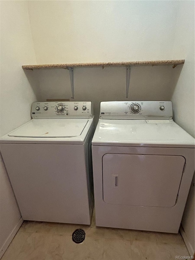 clothes washing area featuring washer and clothes dryer