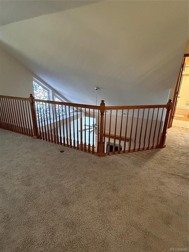 staircase with carpet flooring and vaulted ceiling