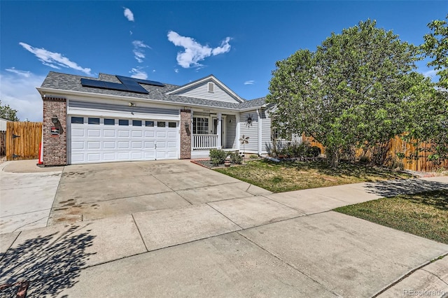 15685 E 50th Ave, Denver, CO 80239 - single story home featuring driveway, brick siding, fence, a garage, and roof mounted solar panels