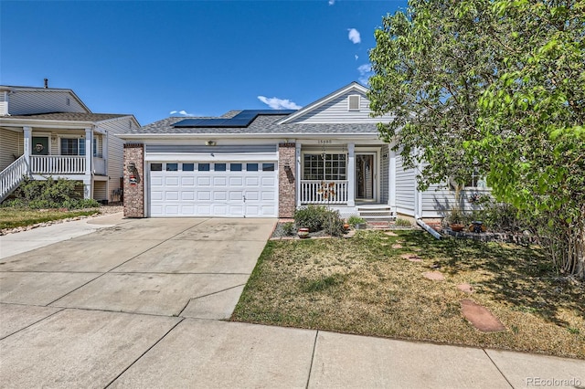 15685 E 50th Ave, Denver, CO 80239 - view of front of property with an attached garage, roof mounted solar panels, a porch, and driveway