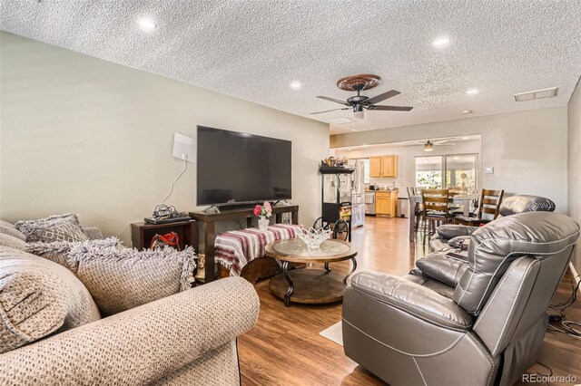 15685 E 50th Ave, Denver, CO 80239 - living area featuring ceiling fan, a textured ceiling, recessed lighting, and light wood-style floors