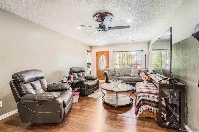 15685 E 50th Ave, Denver, CO 80239 - living area with wood finished floors, a textured ceiling, baseboards, ceiling fan, and recessed lighting