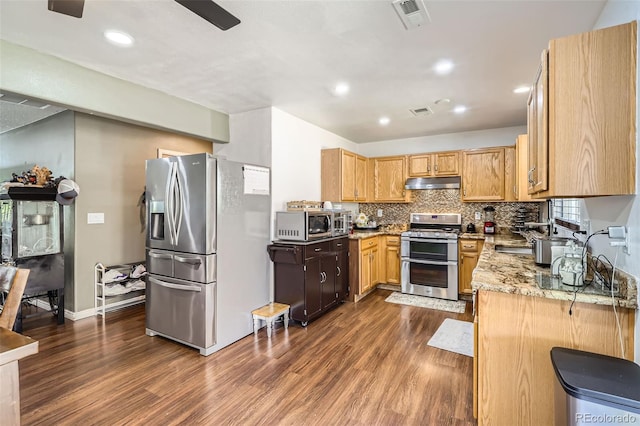 15685 E 50th Ave, Denver, CO 80239 - kitchen with under cabinet range hood, dark wood finished floors, visible vents, and appliances with stainless steel finishes