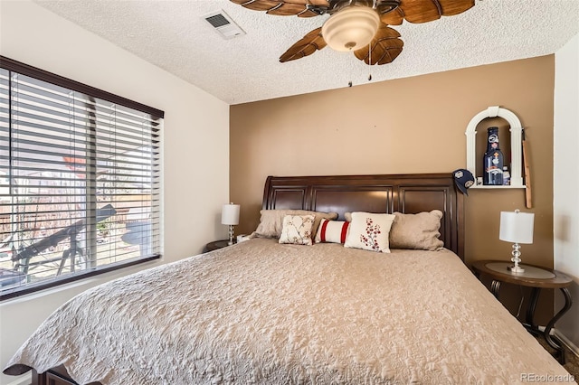 15685 E 50th Ave, Denver, CO 80239 - bedroom with ceiling fan, a textured ceiling, visible vents, and multiple windows