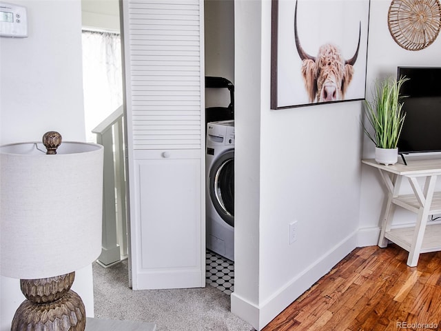 laundry room with laundry area, washer / clothes dryer, wood finished floors, and baseboards